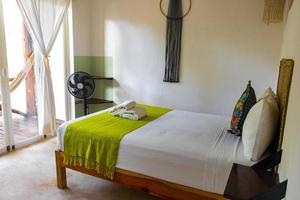 Clean white hotel resort room with green accessories Holbox Mexico. photo