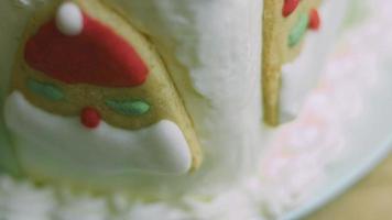 Le pongo la nata a la tarta con ayuda de una bolsita de confitería. pastel de navidad con galletas de jengibre en forma de santa claus video