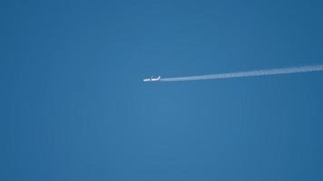 Airplane flying at high altitude with contrail video