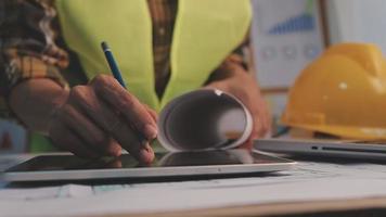 Construction engineer working at blueprint to build large commercial buildings in office. Engineering tools and construction concept. video