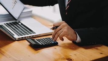 Businessman working with smart phone and laptop and digital tablet computer in office with digital marketing media in virtual icon video