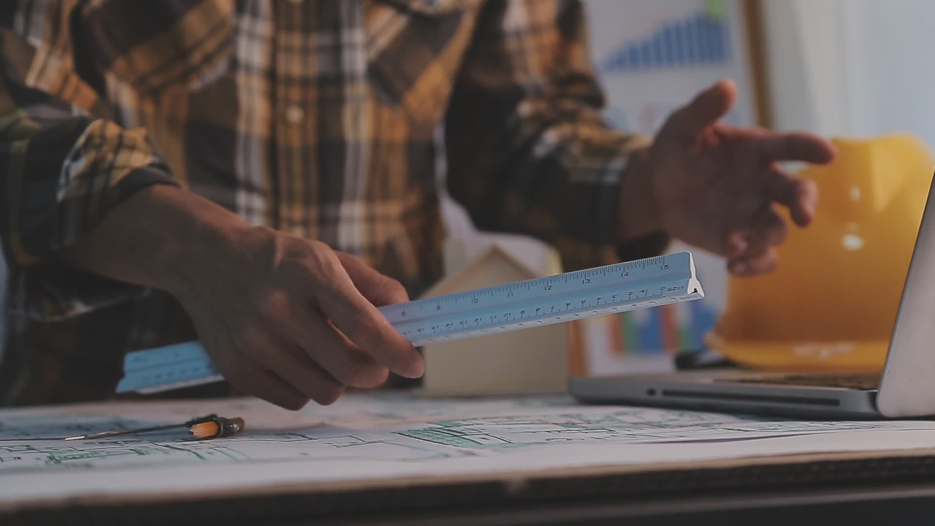 Construction engineer working at blueprint to build large commercial