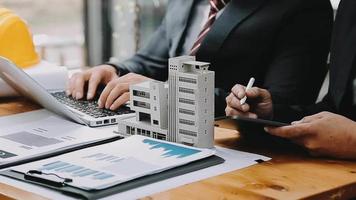 Discussion with a real estate agent, House model with agent and customer discussing for the contract to buy, get insurance or loan real estate or property. video