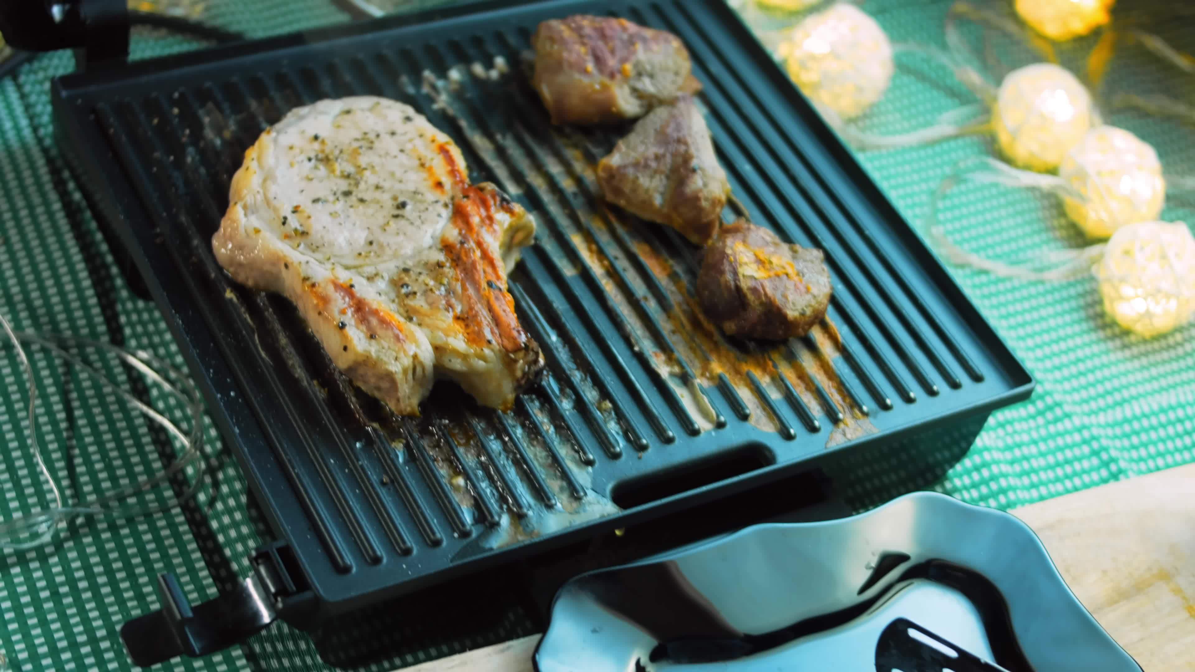The chef grills pork and beef on the grill 15123318 Stock Video at Vecteezy