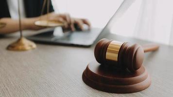 Justice and law concept.Male judge in a courtroom with the gavel, working with, computer and docking keyboard, eyeglasses, on table in morning light video