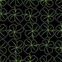 seamless symmetrical pattern of green quatrefoil clover on a black background, texture, design photo