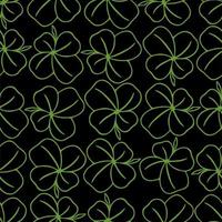 seamless symmetrical pattern of green quatrefoil clover on a black background, texture, design photo