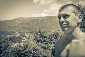 Young man at mountain and alpine panorama in Carinthia Austria. photo