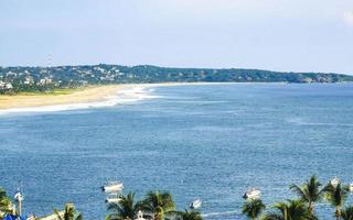 Beautiful natural panorama seascape palm trees beach Puerto Escondido Mexico. photo