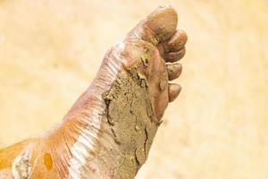 Extremely dirty white dusty mud feet on Holbox island Mexico. photo