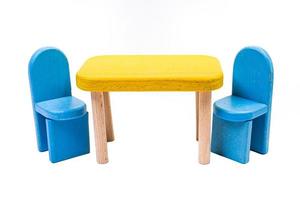 a wooden blue toy chair, a sofa, two chairs with a table, a yellow table, blue upholstered wooden chairs. yellow lamp on isolated white background photo