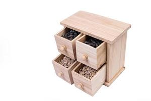 Wooden box cells filled with various spices. wooden box with sunflower seeds, peeled and raw photo