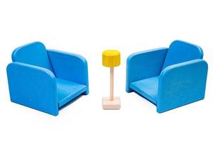 a wooden blue toy chair, a sofa, two chairs with a table, a yellow table, blue upholstered wooden chairs. yellow lamp on isolated white background photo