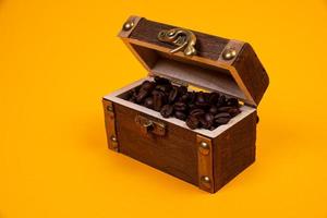 chest with coffee , Image of middle-aged coffee beans. Poured into a pirate chest. Precious, expensive, tonic, invigorating, fragrant, delicious, high-quality, roasted drink. Brown, photo