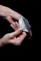 two hands with dollars. Closeup female hand giving money for something with isolated on black background,count, paying, shopping with dollar, corruption, counting dollar banknotes on black photo