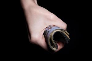 two hands with dollars. Closeup female hand giving money for something with isolated on black background,count, paying, shopping with dollar, corruption, counting dollar banknotes on black photo