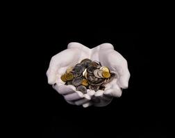 hands holding coins selective and soft focus isolated on black background with copy space. photo