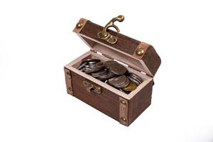 A wooden pirate treasure chest of silver and gold coins isolated on white background. dower chest with old coins collection