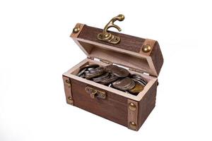 A wooden pirate treasure chest of silver and gold coins isolated on white background. dower chest with old coins collection