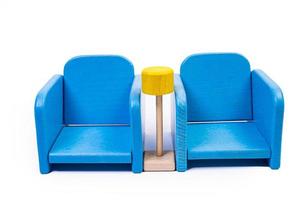 a wooden blue toy chair, a sofa, two chairs with a table, a yellow table, blue upholstered wooden chairs. yellow lamp on isolated white background photo