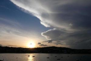 Scattered clouds in the sky indicating a change in weather. photo