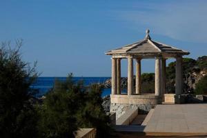 stone gazebo in front of the sea photo