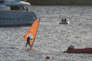 practicing windsurfing in the mediterranean sea, calm sea photo