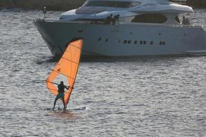 practicing windsurfing in the mediterranean sea, calm sea photo