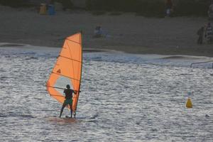 practicing windsurfing in the mediterranean sea, calm sea photo