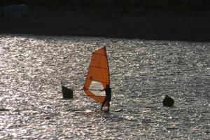 practicing windsurfing in the mediterranean sea, calm sea photo