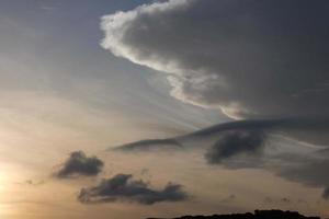 Scattered clouds in the sky indicating a change in weather. photo