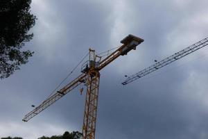 Cranes at work on a building construction site photo