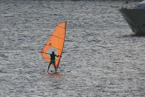 practicing windsurfing in the mediterranean sea, calm sea photo