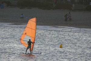 practicing windsurfing in the mediterranean sea, calm sea photo