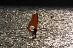 practicing windsurfing in the mediterranean sea, calm sea photo