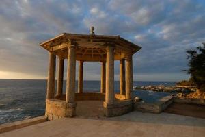 stone gazebo in front of the sea photo