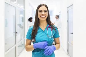 Medical concept of beautiful female doctor with stethoscope, waist up. Medical student. Woman hospital worker looking at camera and smiling, hospital background