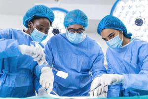 A surgeon's team in uniform performs an operation on a patient at a cardiac surgery clinic. Modern medicine, a professional team of surgeons, health. photo