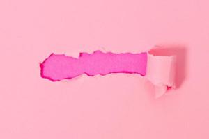 Top view of pink torn paper on pink background. photo