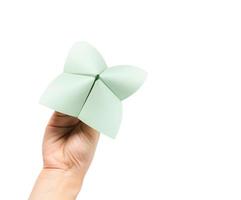 Hand in a paper fortune teller isolated on white background. photo