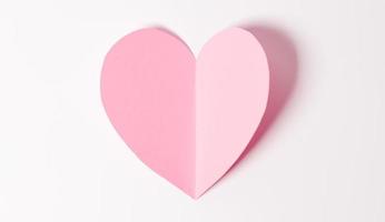 Shape of heart flying on white paper background. photo