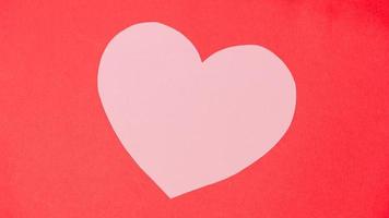 Shape of heart on red paper background. photo