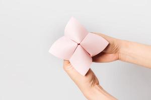 Hand in a paper fortune teller isolated on white background. photo