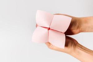 Hand in a paper fortune teller isolated on white background. photo