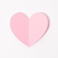 Shape of heart flying on white paper background. photo