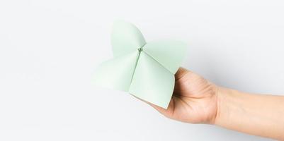 Hand in a paper fortune teller isolated on white background. photo