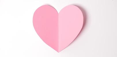 Shape of heart flying on white paper background. photo