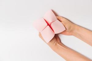 Hand in a paper fortune teller isolated on white background. photo