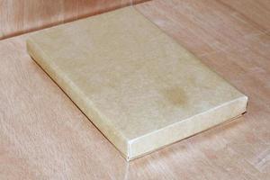 Brown paper box on wooden background mockup photo