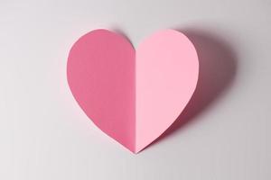 Shape of heart flying on white paper background. photo